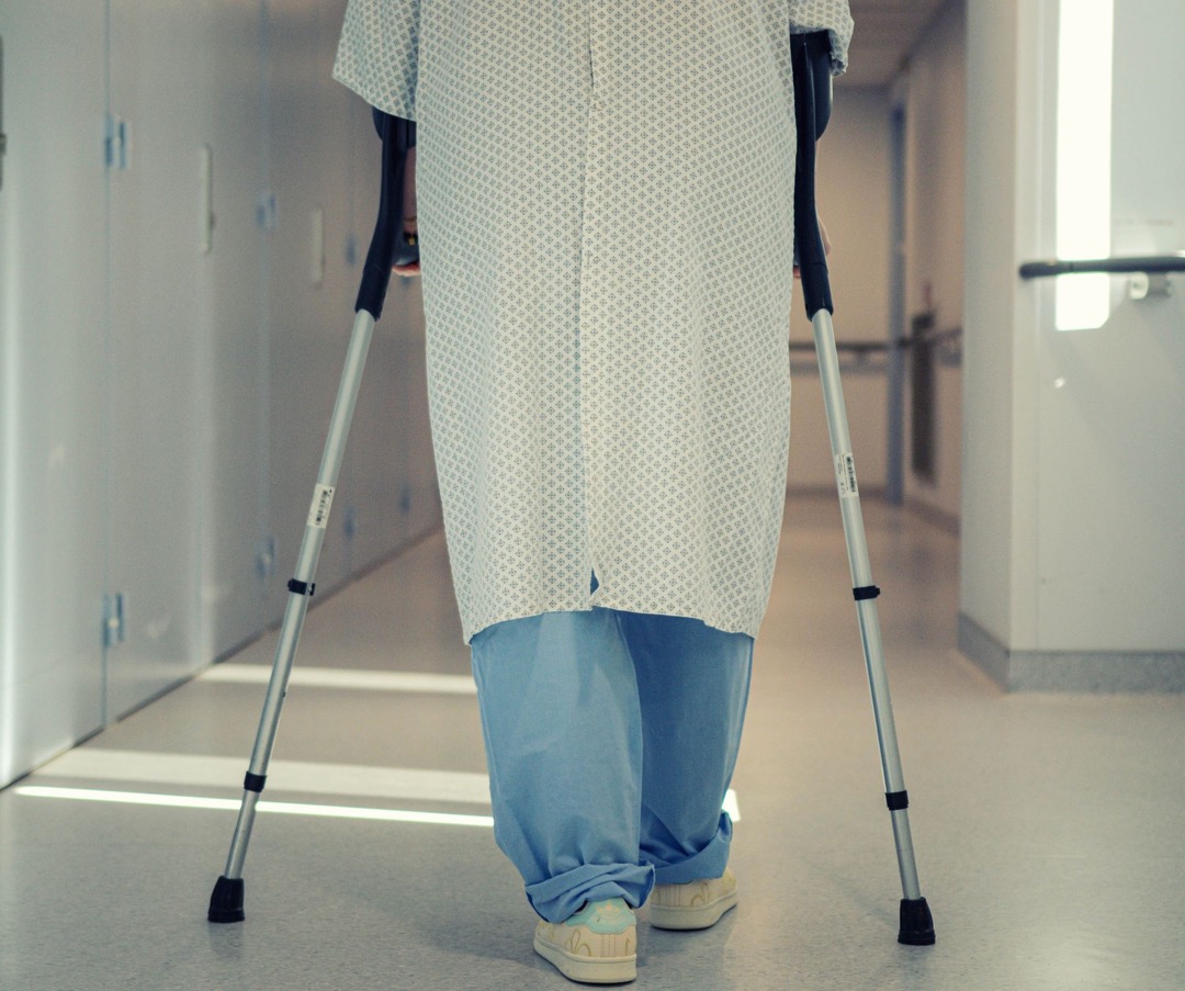 Patient walking with crutches during post-operative recovery
